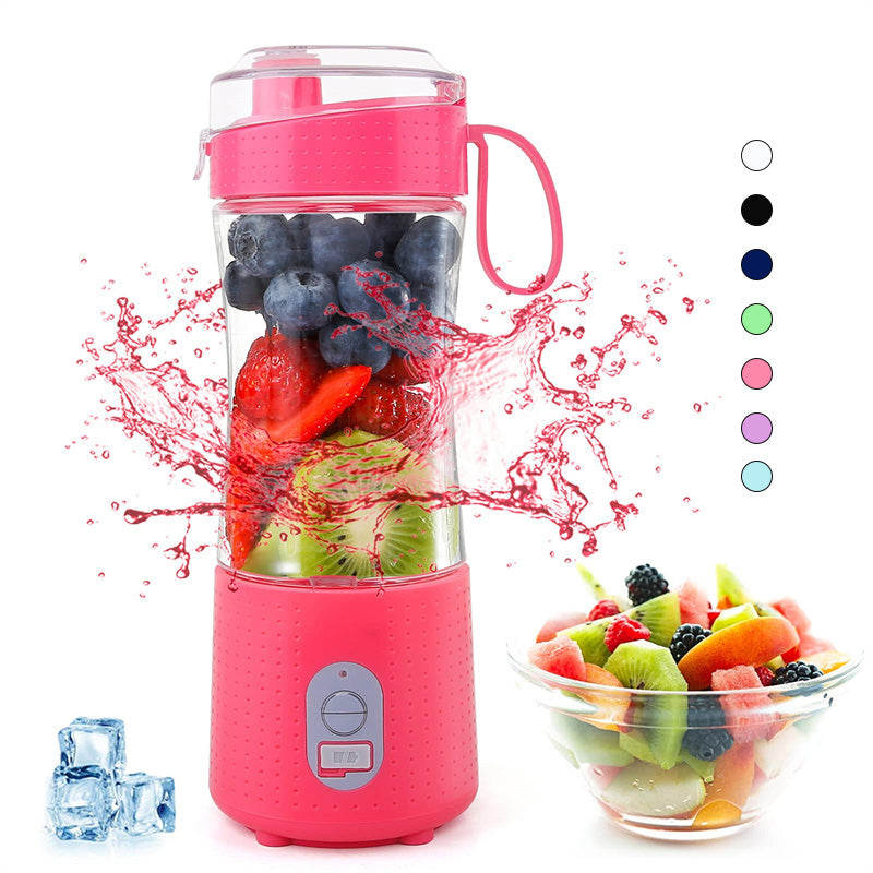 Pink portable blender with fruits and a bowl of mixed fruits on a white background