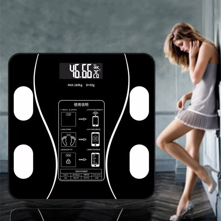 Digital body fat scale with a woman in the background