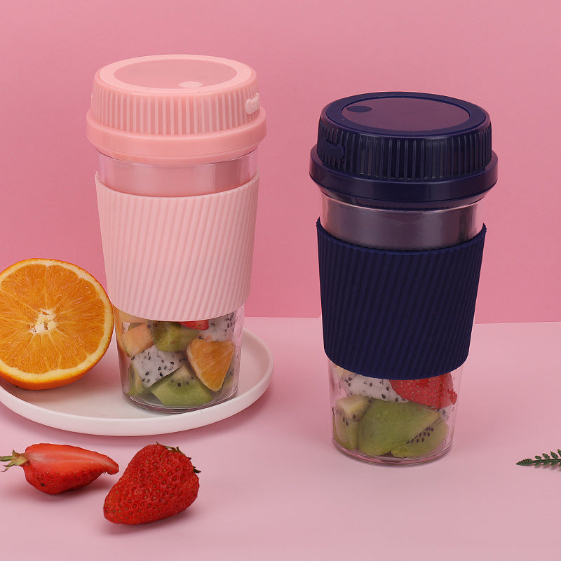 Two travel mugs with fruit inside on a pink background